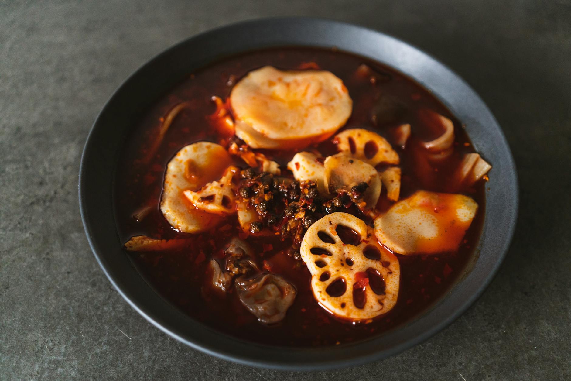 a soup dish on a black bowl