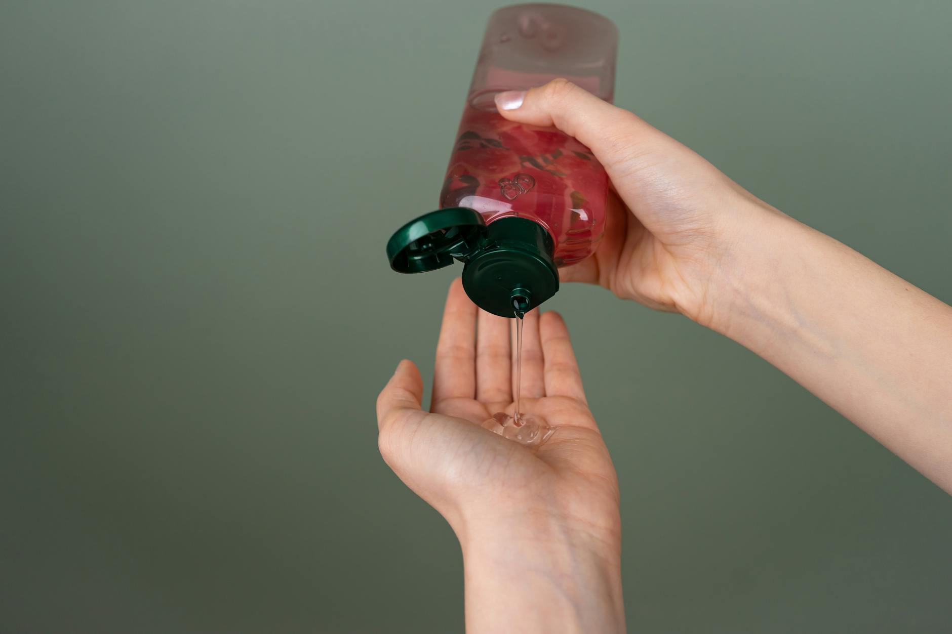 applying liquid gel from a bottle onto hands